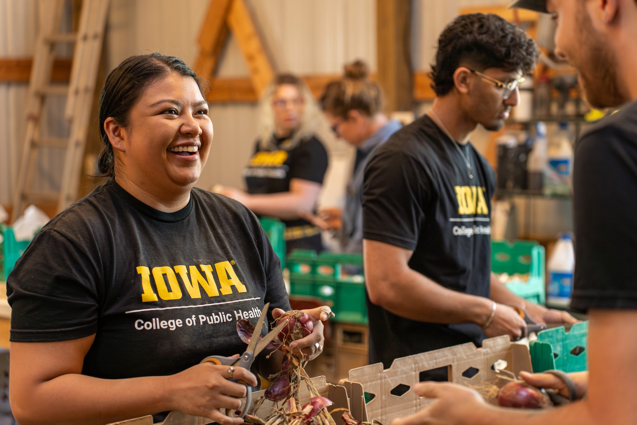 College of Public Health students process vegetables at the annual CPH Day of Service in August of 2024.
