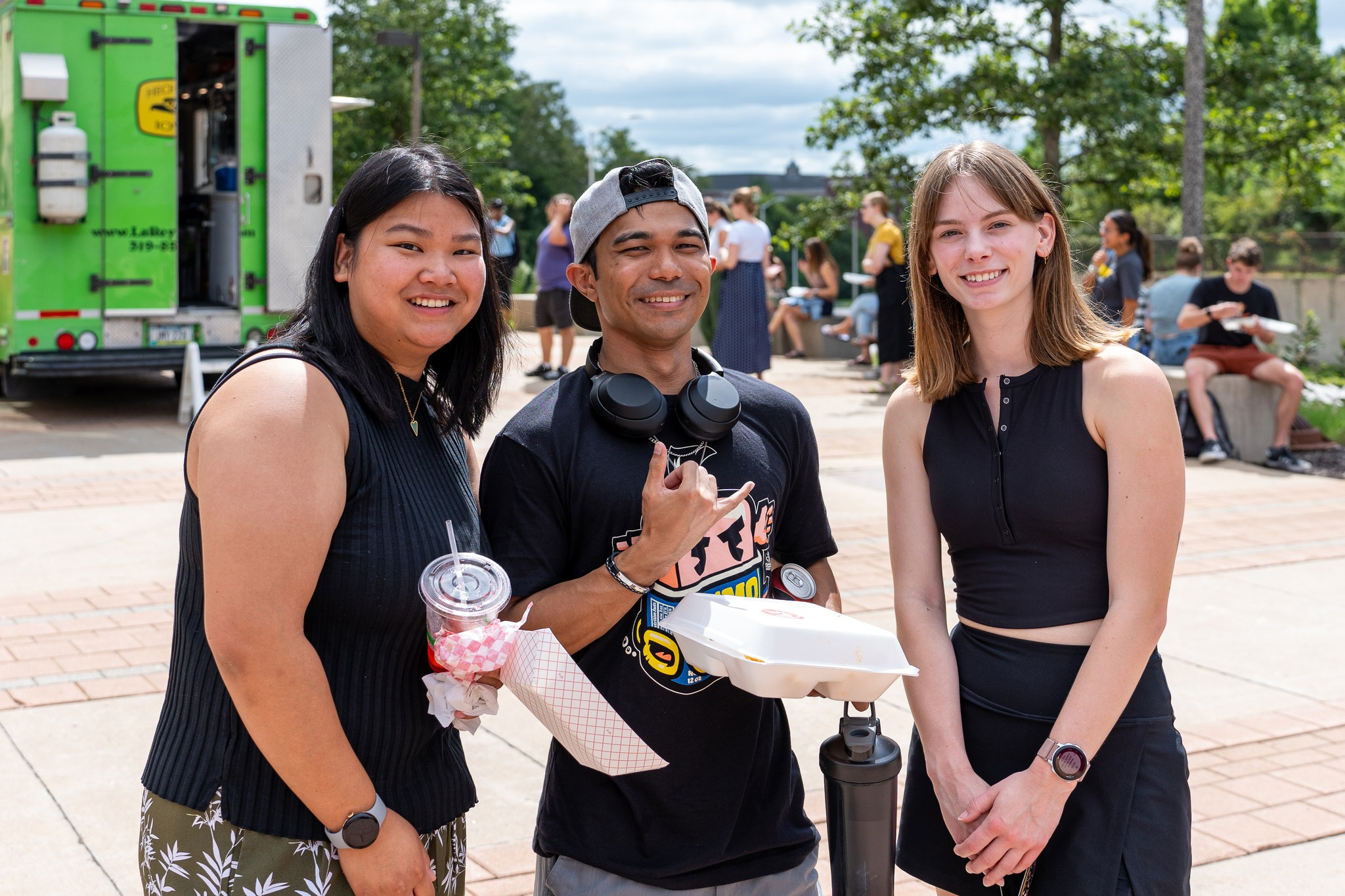 Students enjoying food truck food at the College of Public Health in August 2024.