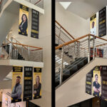 'Dare to Discover' banners featuring student researchers hang in the College of Public Health Building atrium.