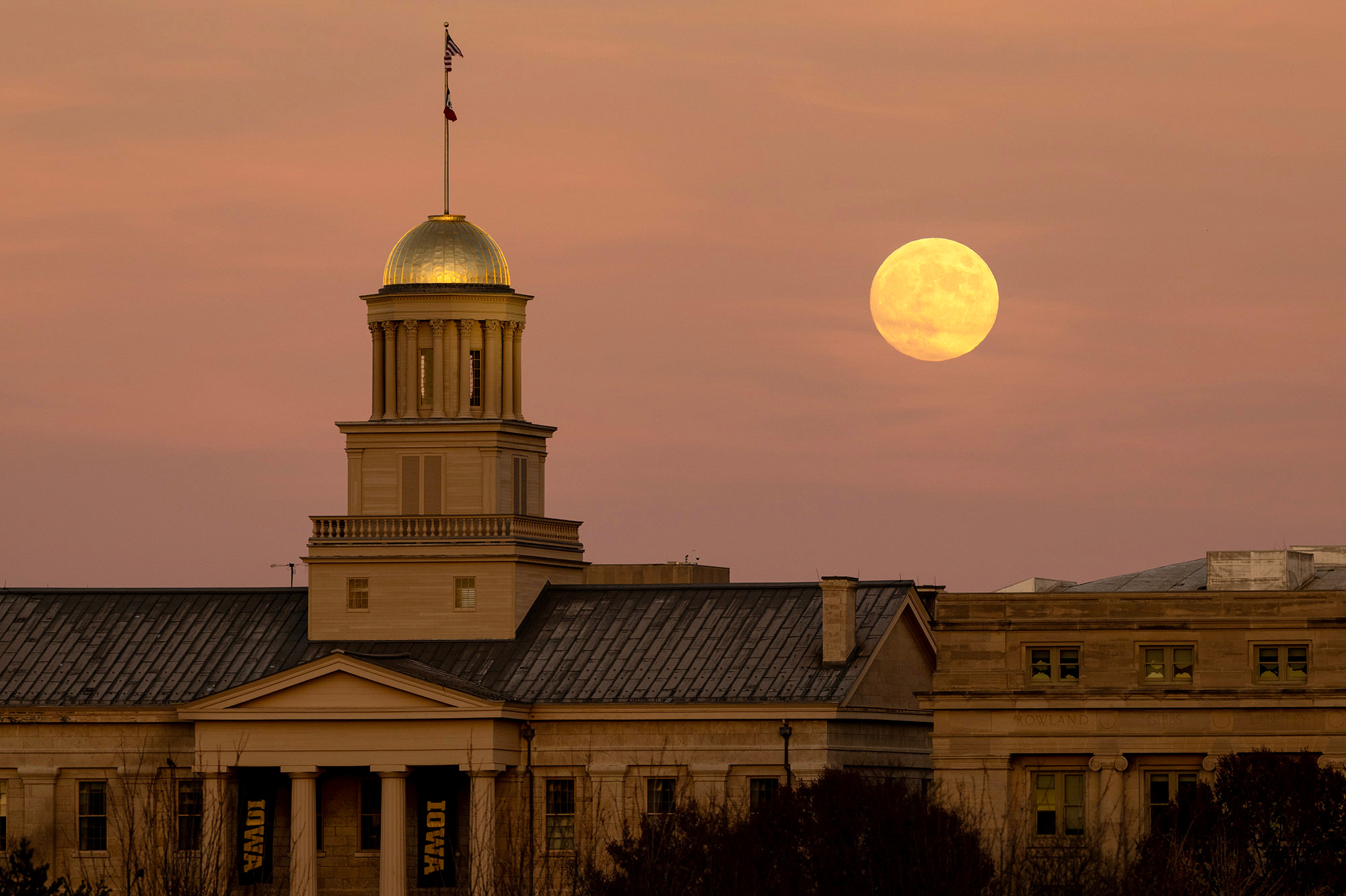 Harvest moon rises over the Old Capitol on an early evening in the fall.