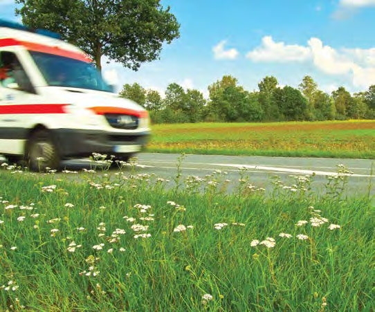 ambulance speeding through rural landscape