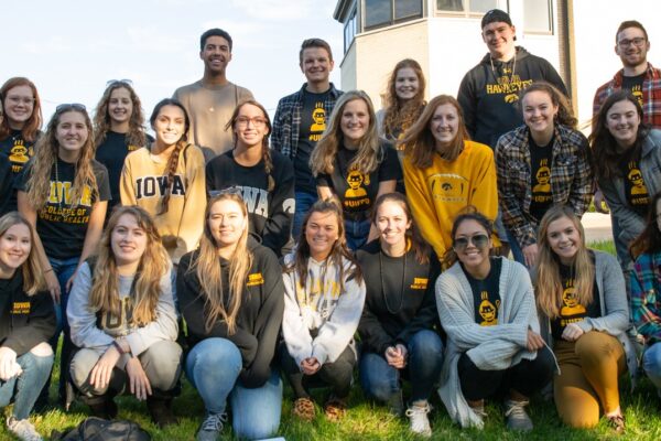 A group of UI College of Public Health students posing in Iowa apparel.