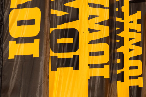 Banners with the block Iowa logo hang on the Pentacrest.