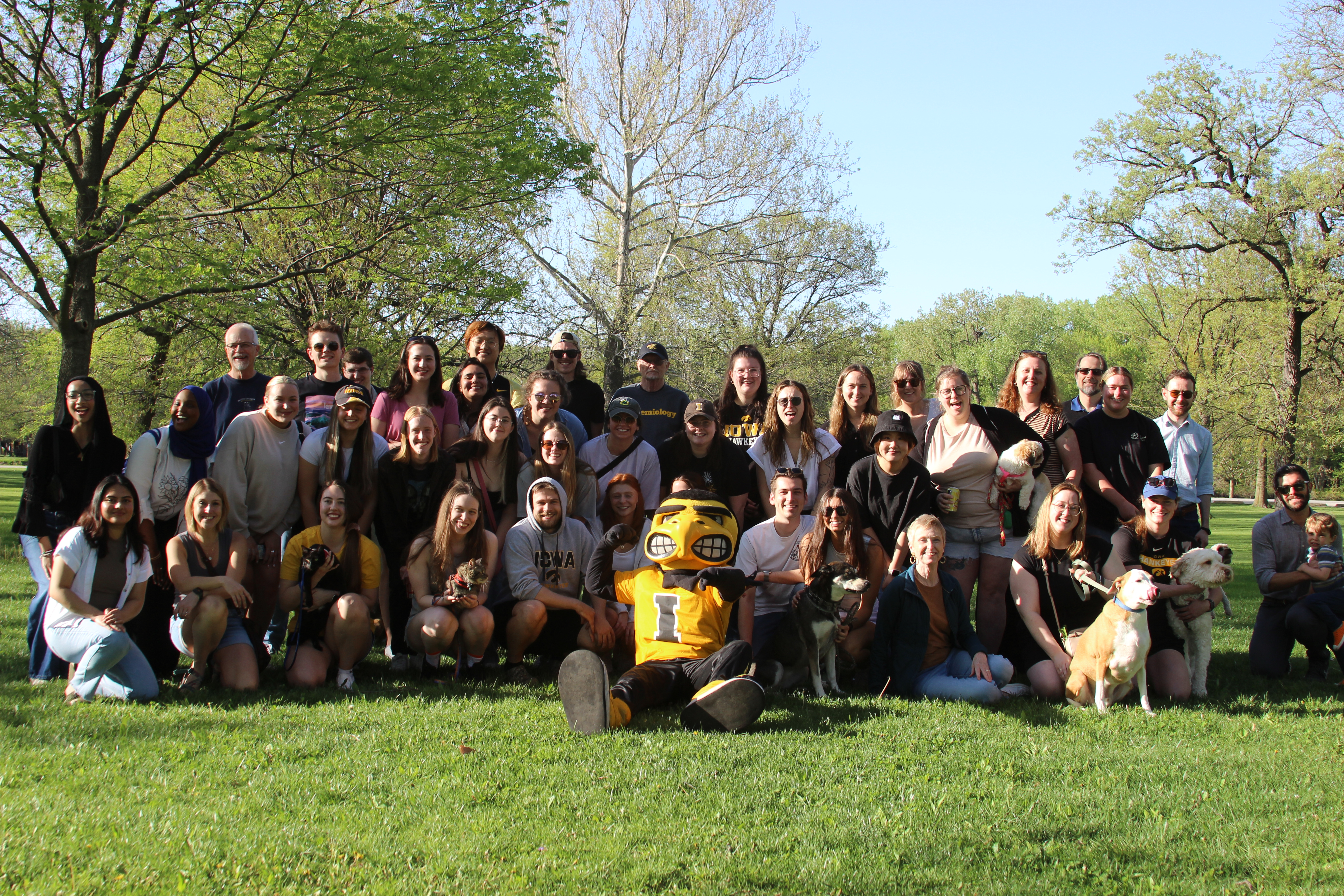Students, staff, faculty, and Herky the Hawk pose for a group picture at the Department of Epidemiology picnic in fall 2025.