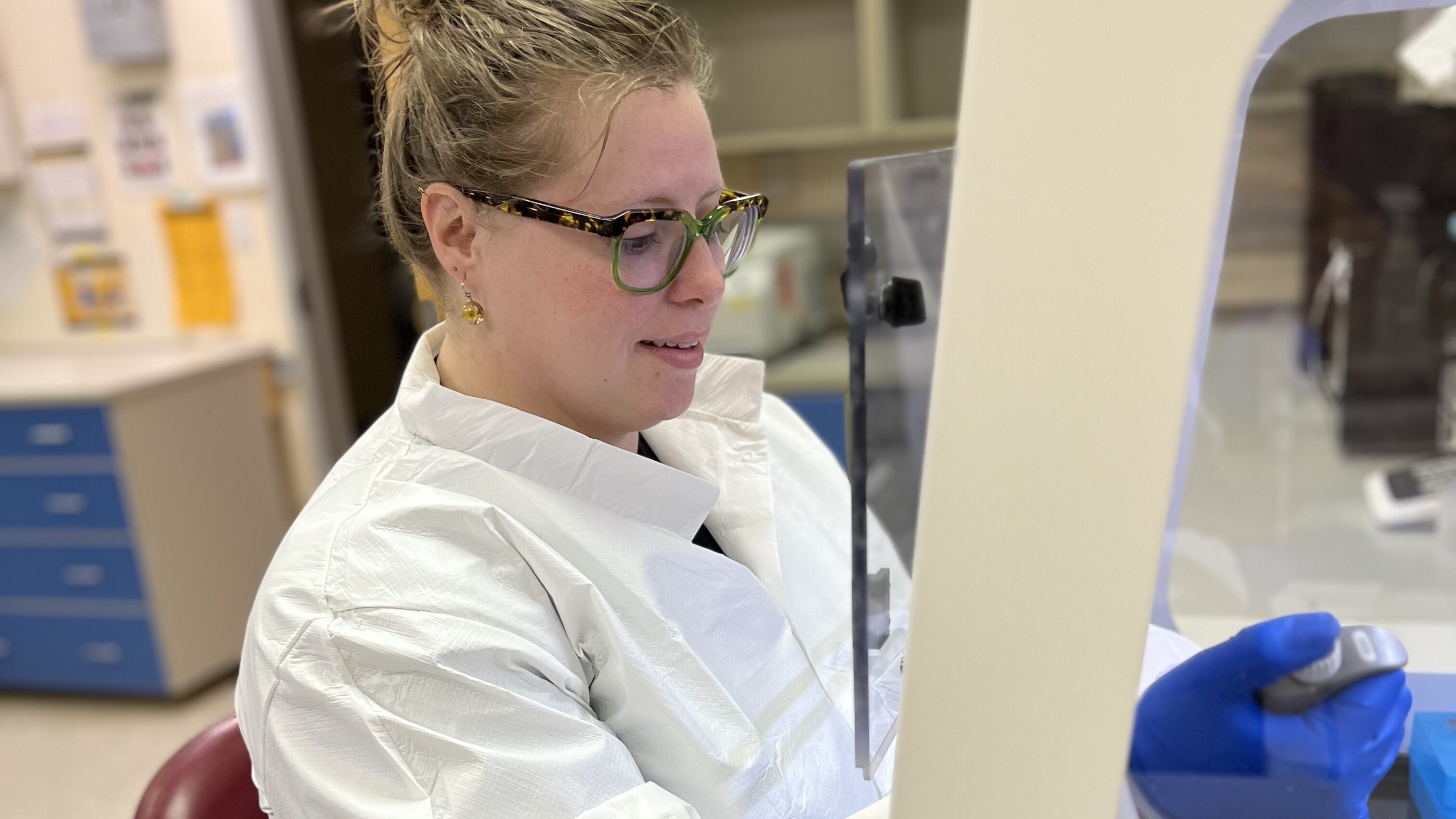 Prof. Shoshannah Eggers using a pipette and a Petri dish in a laboratory.